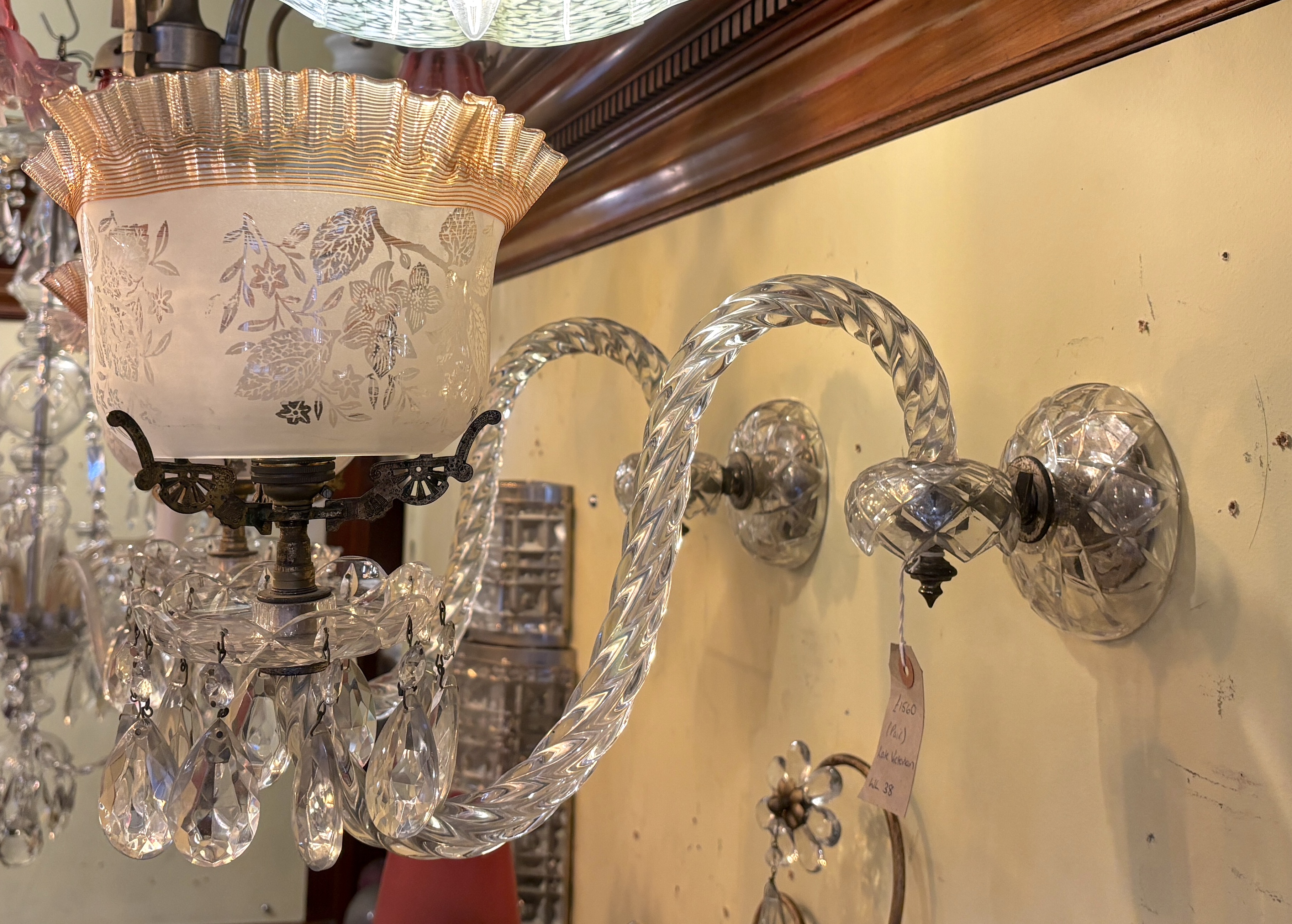 A pair of Victorian cut glass wall lights with etched frilled glass shades, height 32cm. depth 44cm